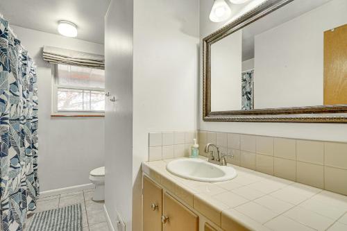 a bathroom with a sink and a mirror and a toilet at Salt Lake City Home Close to Trails and Museums! in Salt Lake City