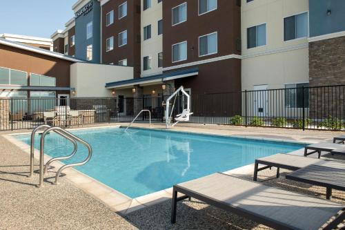 a swimming pool with a slide in a building at Residence Inn by Marriott Fresno Clovis in Clovis