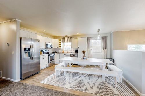 a kitchen with a white table and a refrigerator at Rapid Valley Retreat in Rapid City