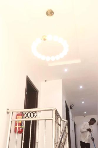 Ein Mann streicht eine Decke mit Licht in der Unterkunft Ge-Mart Hotels and Suites in Lagos