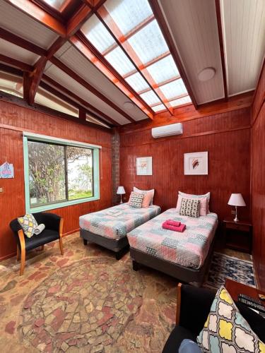 a living room with two beds and a skylight at alojamiento Lof tüng in Los Vilos