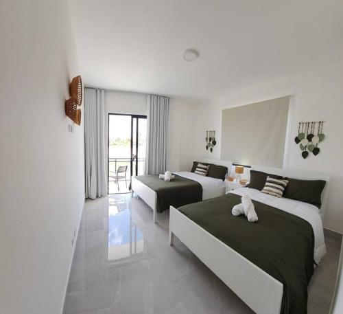een hotelkamer met 2 bedden en een balkon bij Luxury Villa in Punta Cana in Punta Cana