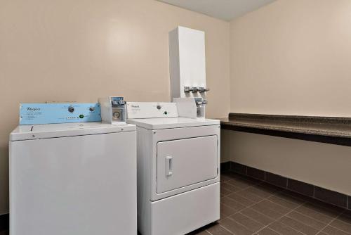 a laundry room with two refrigerators and a counter at Quality Inn Memphis Northeast near I-40 in Memphis
