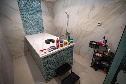 a bathroom with a shower with a counter and a sink at Best Western Plus Danat Almansak Hotel in Abha