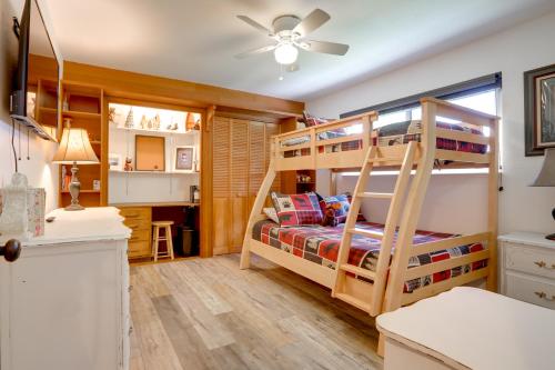 a bedroom with two bunk beds and a desk at Pollock Pines Cabin Retreat with Hot Tub and Deck in Pollock Pines
