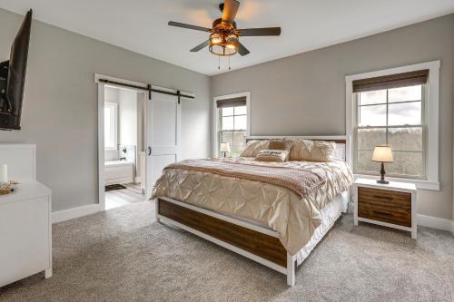 a bedroom with a bed and a ceiling fan at Modern Sadieville Home with Yard and Gas Grill! in Corinth