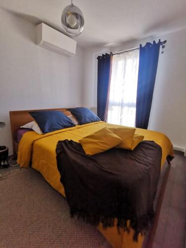 a bedroom with a large bed with a window at Chambre chez habitant proche Métro in Toulouse