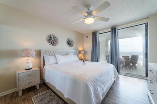 a bedroom with a bed and a ceiling fan at Pelican Pointe 504 in Orange Beach