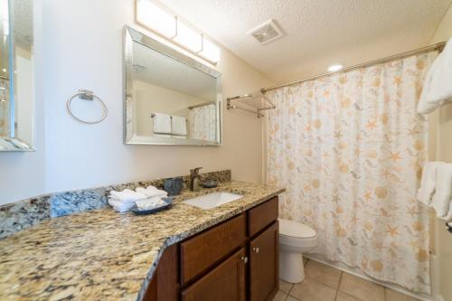a bathroom with a sink and a toilet at Pelican Pointe 504 in Orange Beach