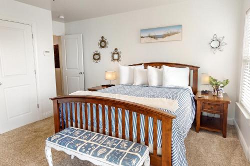 a bedroom with a bed and a bench in it at Surf Station in Carolina Beach