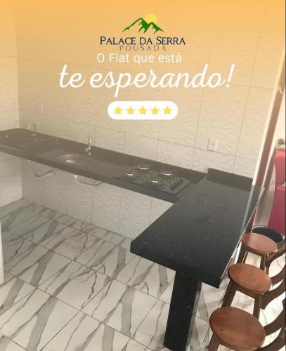 a table in a kitchen with a sign on the wall at Flats Palace da serra in Serra de São Bento