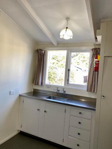 a kitchen with a sink and a window at Sea View Motel - Unit 5 in Kaikoura