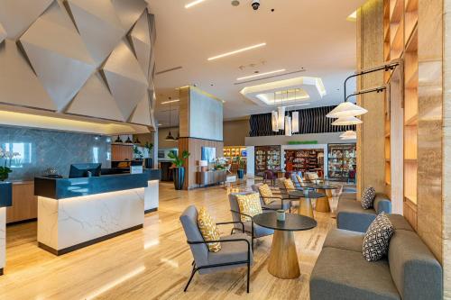 a lobby of a store with tables and chairs at Crowne Plaza Santo Domingo by IHG in Santo Domingo