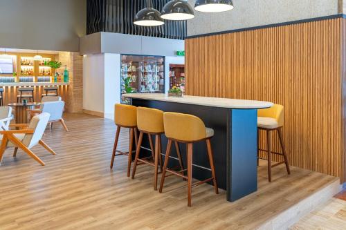 a bar in a restaurant with chairs and tables at Crowne Plaza Santo Domingo by IHG in Santo Domingo