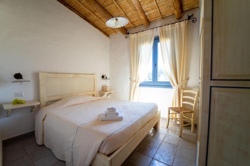 Postel nebo postele na pokoji v ubytování Residence Isola dei Mori
