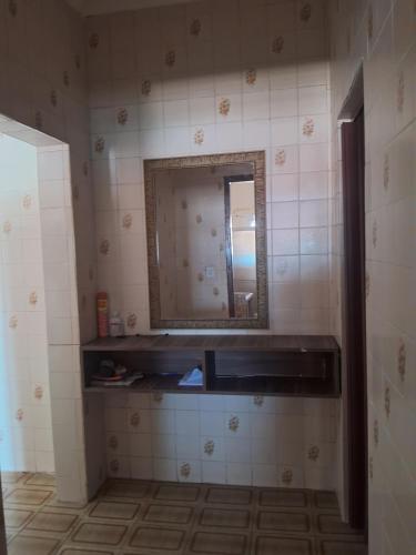 a bathroom with a sink and a mirror on the wall at Casa da maci in Mauá
