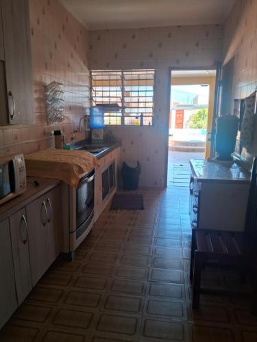 a kitchen with a sink and a stove top oven at Casa da maci in Mauá