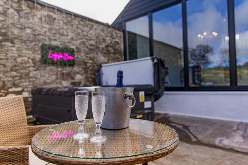 a table with three wine glasses on a patio at Ladyston Barn in Muthill