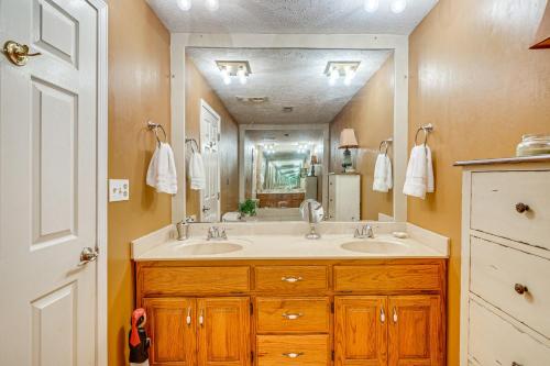 a bathroom with two sinks and a large mirror at Lakefront Leesburg Home with Private Dock and Ramp! in Centre