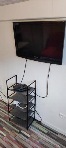 a flat screen tv hanging on a wall at Studio fonctionnel avec espace extérieur partagé in Villepinte