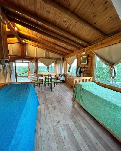 a bedroom with two beds and a table and chairs at Amaneceres de San Isidro in José de la Quintana