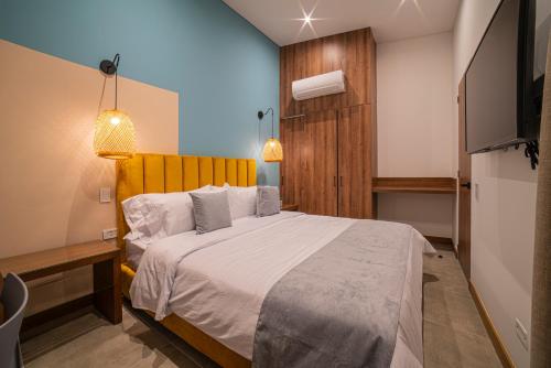 Postel nebo postele na pokoji v ubytování ERE Centenario Luxury Suites