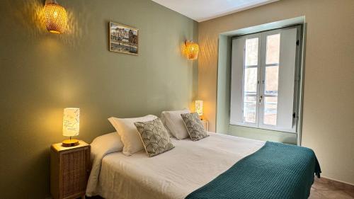 a bedroom with a bed and a window at COLOMBA Hôtel Restaurant in Bonifacio