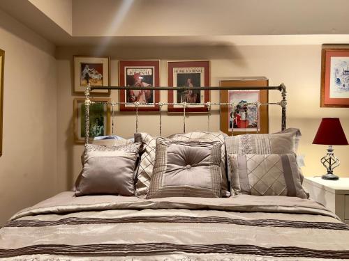 um quarto com uma cama grande com muitas almofadas em Charming 1-bedroom Basement Close to DC Pets Allowed em Arlington