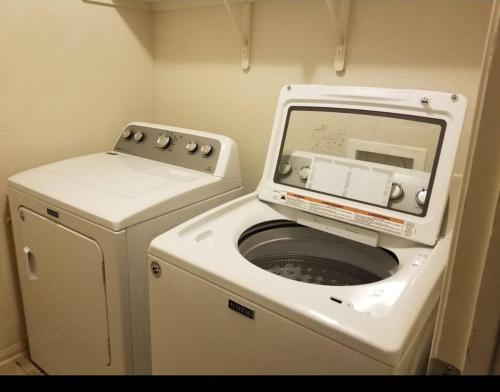 a washing machine and a washer in a small room at Taylors Furnished Home Comforts 3bd 1 & a half bath in Temple