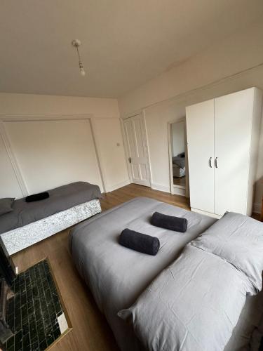 a bedroom with two beds and aaptop at Very Nice Triple Room at 2 Iveragh Rd-5 in Dublin