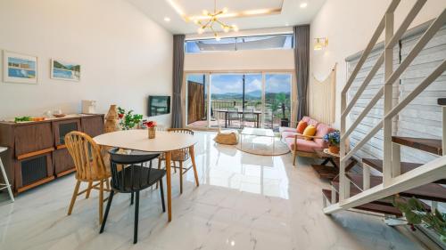 a living room with a table and chairs at Majoong Pool Villa Pension in Gyeongju