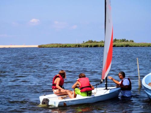 a group of people on a sail boat in the water at Hotel La Tartaruga Bianca in Valledoria