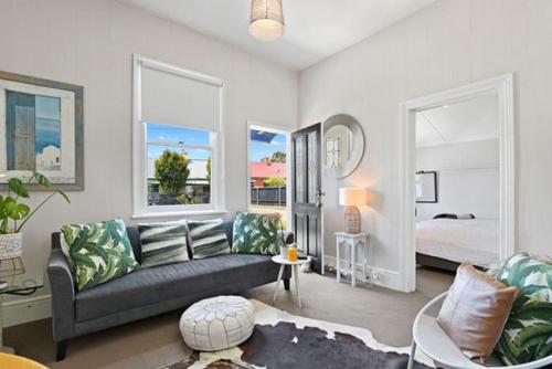 a living room with a couch and a bedroom at North Hobart cottage in Hobart