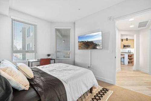 a bedroom with a large bed in a room with windows at Luxury Modern Condo in Irvine in Santa Ana