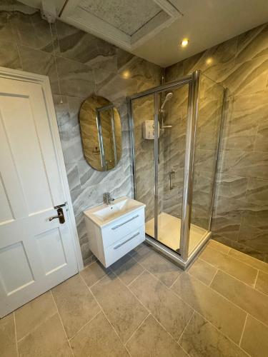 a bathroom with a shower and a sink at Nice Triple Room at 2 Iveragh Rd-7 in Dublin