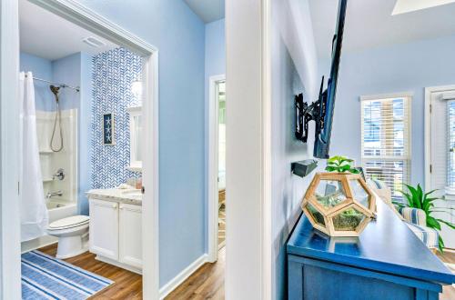 a blue bathroom with a toilet and a sink at Half Shell Hideaway in Port Saint Joe