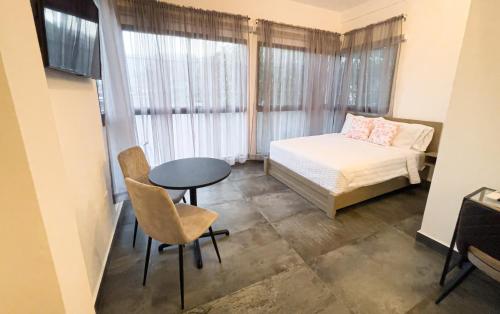 Habitación pequeña con cama, mesa y silla en Hotelito Bonito Eli & Edw en Santo Domingo