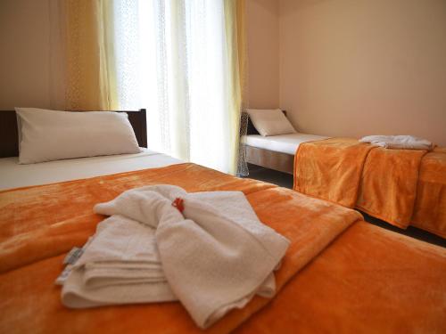 a room with two beds with towels on them at Dimitra Apartments Zakros Village in Káto Zákros