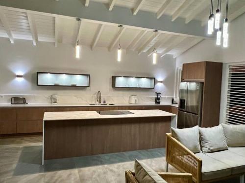 a kitchen with a large island in the middle at NEW Amazing Villa with Sea Views-Walk to Beach-8 guests-Private Pool in Willibrordus