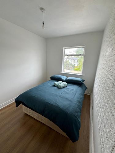 a bedroom with a bed with two pillows and a window at Nice Double Room at 2 Iveragh Rd-8 in Dublin