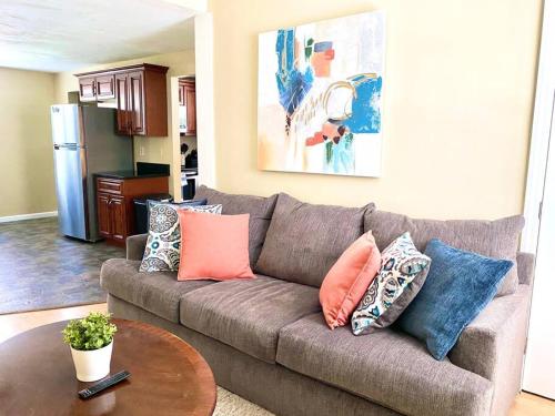 a living room with a couch with pillows on it at Comfy Easeful Two Bed Apartment 30 min to Boston in Brockton