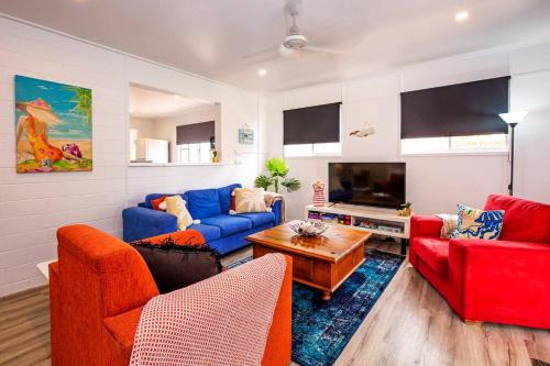 a living room with two couches and a tv at Puppies&Pancakes at Innes Park Opp Park&Beach Dogs welcome inside in Pemberton
