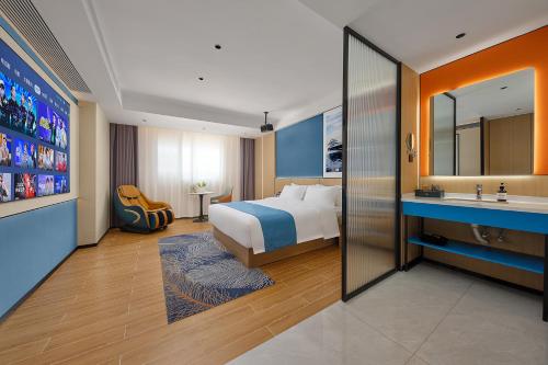 a hotel room with a bed and a sink at Pearl Hotel - Gongbei Port Zhuhai in Zhuhai