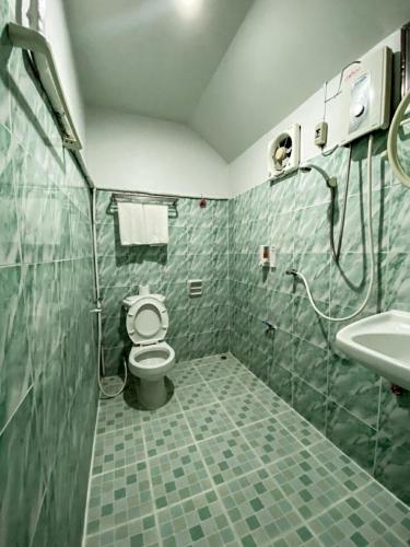 a bathroom with a toilet and a sink at Orchid house in Chiang Rai