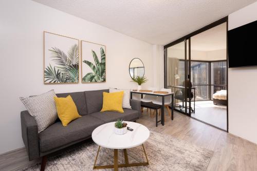 a living room with a couch and a table at Bishop Suites at Executive Centre in Honolulu