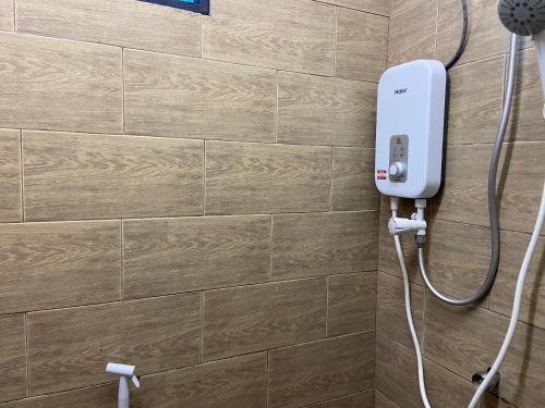 a bathroom with a soap dispenser on a wall at Padang Besar Green Inn in Padang Besar