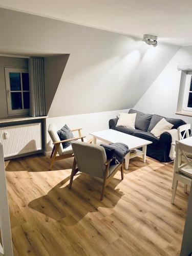 a living room with a couch and a table at Ordinger-Diek-8 in Brösum
