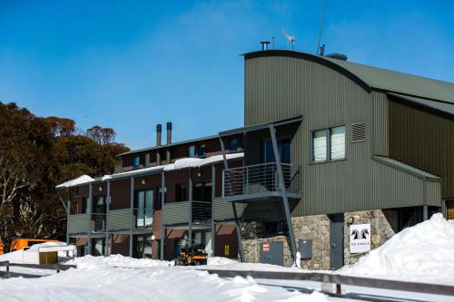 a building with snow in front of it at Studio 2 - The Stables Perisher in Perisher Valley