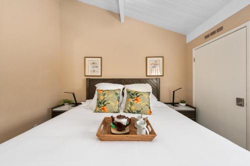 a bedroom with a large white bed with two pillows at Napili Point C40 in Kahana