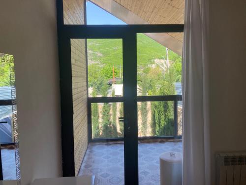 a room with a window with a view of a yard at Sheki Guest Villa in Sheki